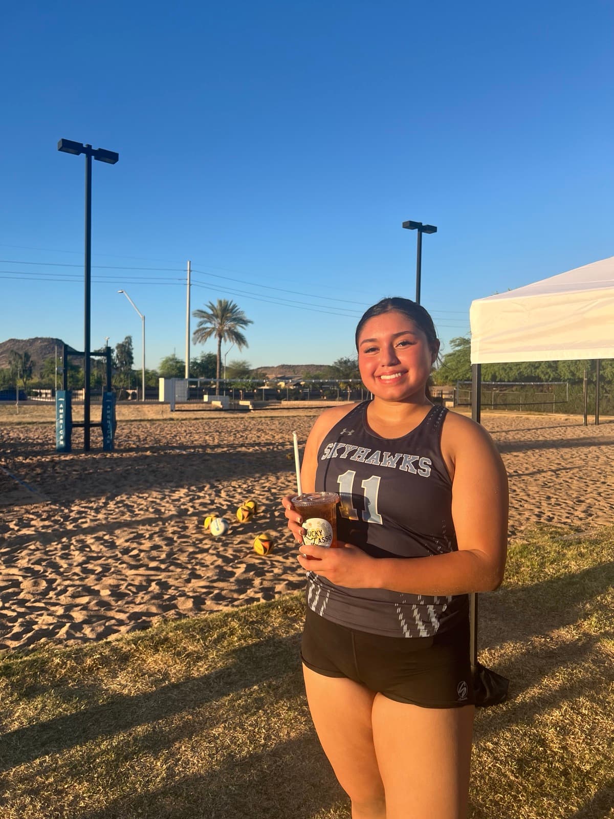 Customer enjoying a Lucky Lasso drink at golden hour